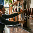 inkeeper pours beer from a tap at Copper Vine Pub in New Orleans