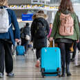 People enter LaGuardia Airport (LGA) on one of the busiest travel days of the year