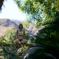 woman doing yoga in the foliage at sensei porcupine creek in coachella valley