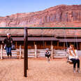 family on a swing at red cliffs lodge near moab, utah