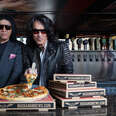 gene simmons of KISS posing with pizza boxes at Rock & Brews restaurant in LA